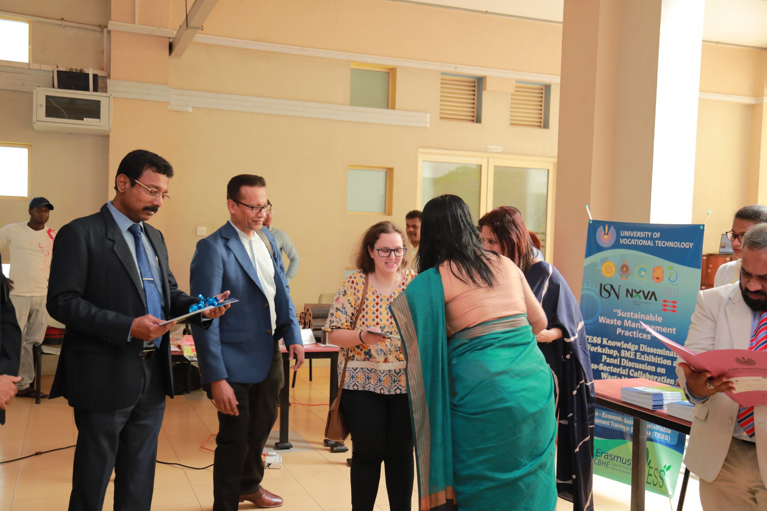 A TESS member receives the book - Good Waste Management Practices